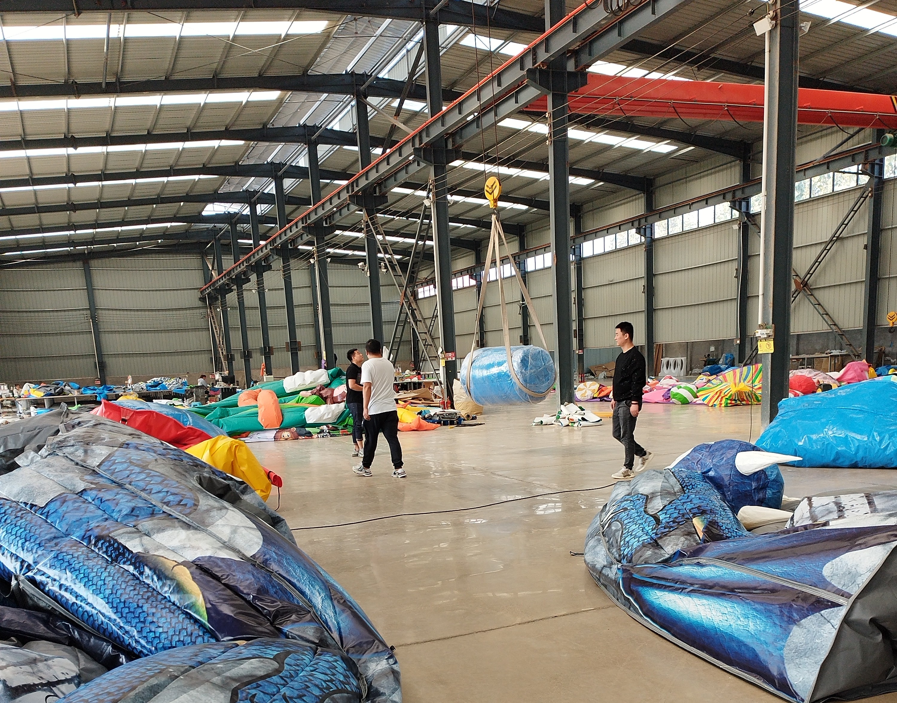 Overhead crane transporting materials across the inflatable production workshop